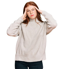 Young read head woman wearing casual winter sweater suffering from headache desperate and stressed because pain and migraine. hands on head.