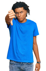 Young african american man wearing casual clothes looking unhappy and angry showing rejection and negative with thumbs down gesture. bad expression.