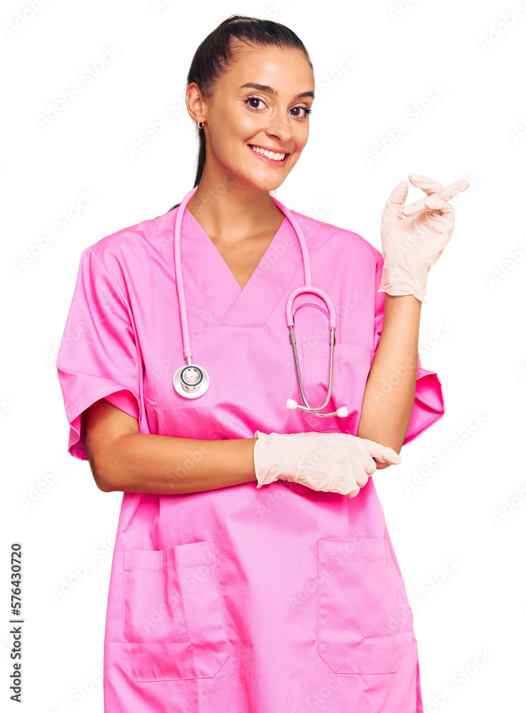 Poster young hispanic woman wearing doctor uniform and stethoscope smiling happy pointing with hand and fin