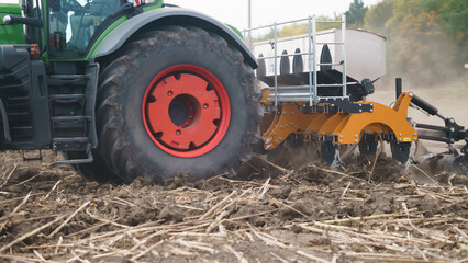 Tractor working in the field. Autumn tillage. Deep ripping with powerful tractor