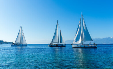 Fototapeta premium boats and yachts at the sailing regatta on open water. Sailing on the wind waves in the sea.