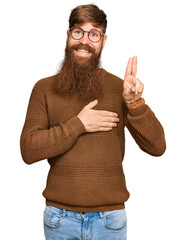 Young irish redhead man wearing casual clothes and glasses smiling swearing with hand on chest and...