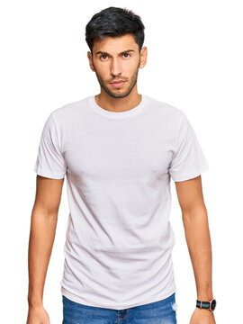 Young handsome man wearing casual white tshirt skeptic and nervous, frowning upset because of problem. negative person.