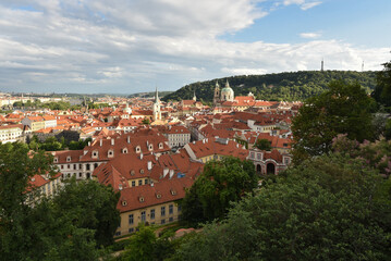 Fototapeta na wymiar View on Prague city during summer with houses, trees and churches, Czech republic.