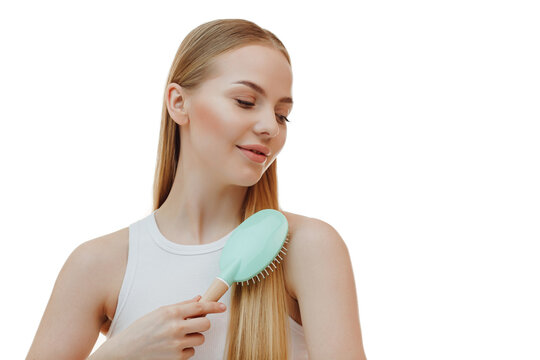 woman with long beautiful blond hair isolated on white background holds hairdressing accessories. Dyeing and hair care. Shiny smooth blonde hair.