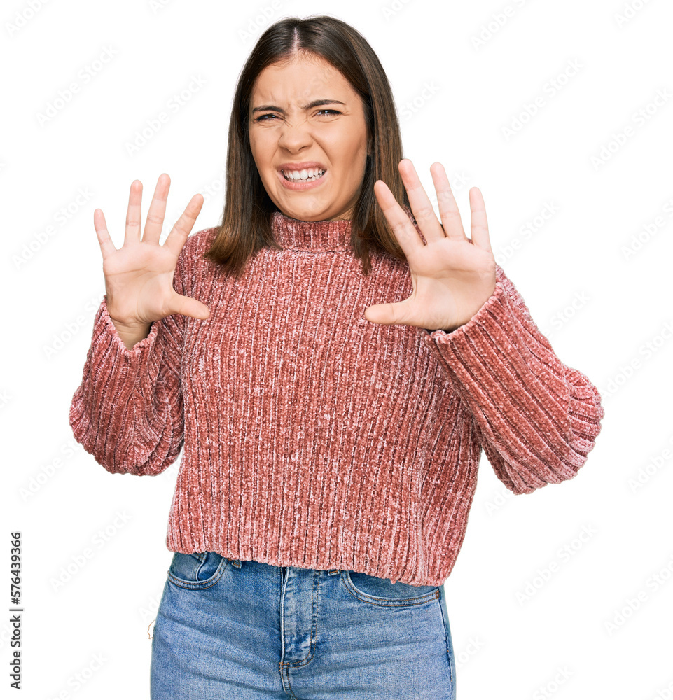 Poster Young beautiful woman wearing casual clothes afraid and terrified with fear expression stop gesture with hands, shouting in shock. panic concept.