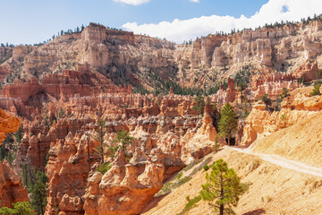 Peekaboo hiking trail with scenic view of massive steep hoodoo sandstone rock formation towers in Bryce Canyon National Park, Utah, USA. Barren desert landscape in natural amphitheatre in summer