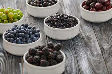 Ripe blueberries, assortment of ripe berries in bowls