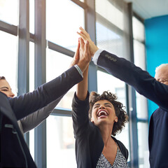Be bold in the pursuit of success. Shot of a group of colleagues giving each other a high five.