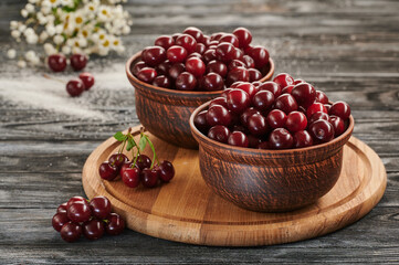 berries in bowls, ripe cherries in the plates