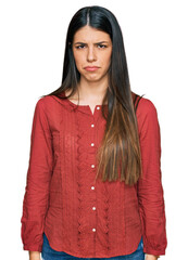 Young hispanic woman wearing casual clothes skeptic and nervous, frowning upset because of problem. negative person.