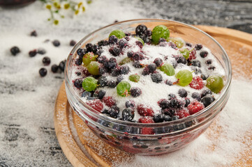 sugar for preservation in bowls on a wooden table, ripe cherries on the table