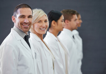 Fototapeta premium Your first line of defense against illness. Cropped shot of a group of doctors standing in a row.