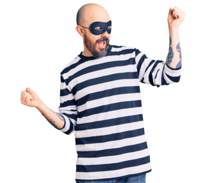 Young handsome man wearing burglar mask dancing happy and cheerful, smiling moving casual and confident listening to music