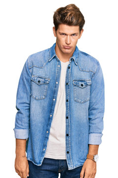 Handsome caucasian man wearing casual denim jacket skeptic and nervous, frowning upset because of problem. negative person.