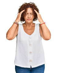 Beautiful middle age mature woman wearing casual white shirt with hand on head for pain in head because stress. suffering migraine.