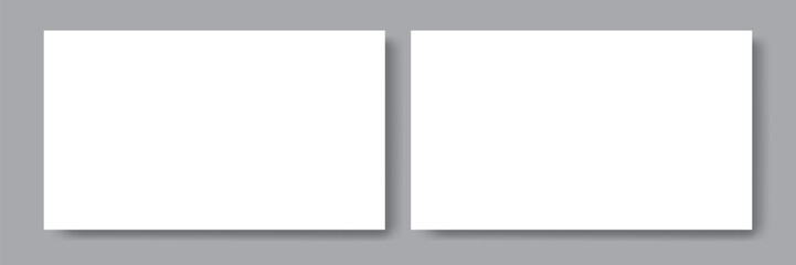 Obraz premium Two white blank papers with shadows on the grey background. Templates for presentation of design. Mock up for visit card or flyer, cover, poster. mock up design template.