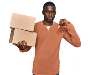 Young african american man holding delivery package with angry face, negative sign showing dislike with thumbs down, rejection concept