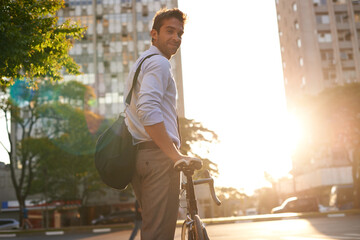 Take a bike. Shot of a businessman commuting to work with his bicycle.