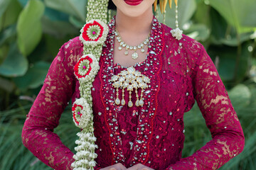 Indonesian wedding accessories. A female model who wears make-up and a traditional wedding dress or...
