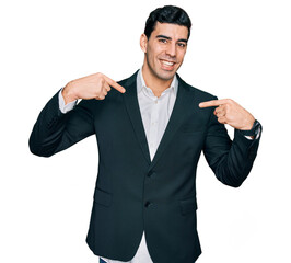 Handsome hispanic man wearing business clothes looking confident with smile on face, pointing oneself with fingers proud and happy.