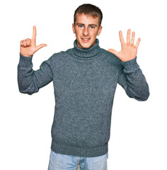 Naklejka premium Young blond man wearing casual clothes showing and pointing up with fingers number seven while smiling confident and happy.