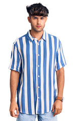 Young hispanic man wearing casual clothes skeptic and nervous, frowning upset because of problem. negative person.