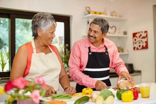 Cooking With Love. Shot Of A Happy Senior Couple Cooking A Healthy Meal Together At Home.