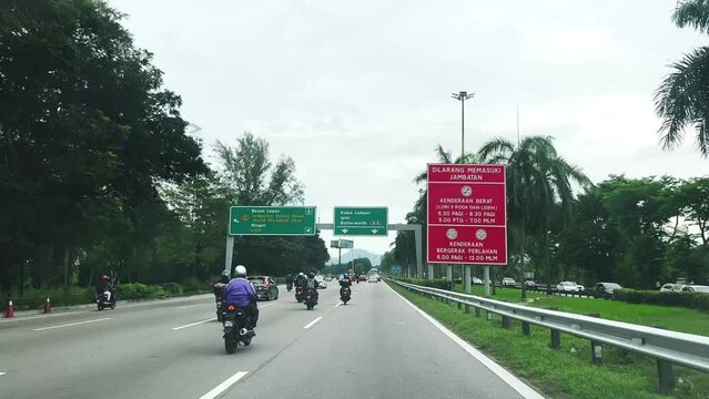 Bikes and cars moving on a road in Bayan Lepas Malaysia