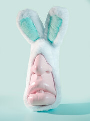 Easter Whimsy & Weird: A Pastel-Colored Human Head Dons Bunny Rabbit Ears for a Quirky, Offbeat Look