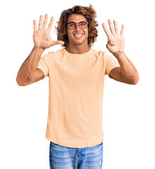 Young hispanic man wearing casual clothes and glasses showing and pointing up with fingers number nine while smiling confident and happy.