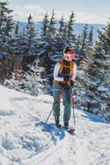 Mountaineer backcountry ski walking ski alpinist in the mountains. Ski touring in alpine landscape with snowy trees. Adventure winter sport. Kralova hola, Slovakia © Zedspider