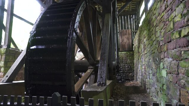 Hopewell Furnace National Historic Site in Pennsylvania. Hopewell's 22-foot diameter waterwheel catches a flow of water from French Creek to power the furnace's air blast machinery.