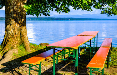 typical bavarian beergarden with wooden benches and tables