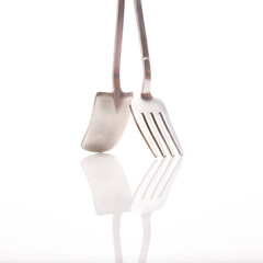 decorative fork and spoons in the form of spades on a white background. food tools.