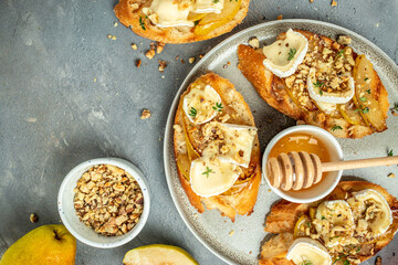 toasts croutons with cheese camembert and pear, honey, walnut, banner, menu, recipe place for text, top view