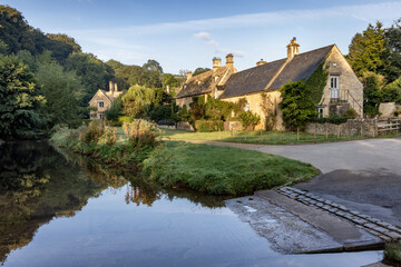 Fototapeta na wymiar The ford at the River Eye in the beautiful Cotswold village of Upper Slaughter in Gloucestershire.