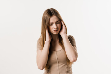 Migraine is a strong headache of girl isolated on white background. Overstressed young woman...