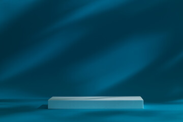 Dark moody podium stage for products or cosmetics against dark blue background and leaves shadows...