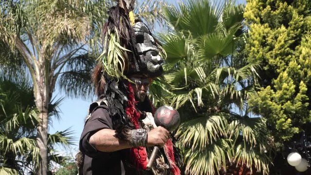 a dancer with pre-Hispanic instruments during a ceremony