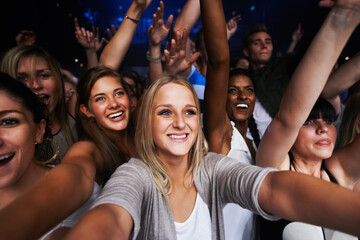 Attractive female fans enjoying a concert- This concert was created for the sole purpose of this photo shoot, featuring 300 models and 3 live bands. All people in this shoot are model released - obrazy, fototapety, plakaty