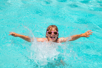 Kids summer vacation, swimming and relax. Children playing in the swimming pool. Summer activity.