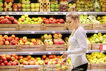 Woman buying fruits and vegetables at the market