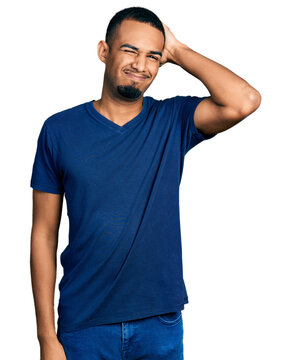 Young African American Man Wearing Casual T Shirt Confuse And Wonder About Question. Uncertain With Doubt, Thinking With Hand On Head. Pensive Concept.