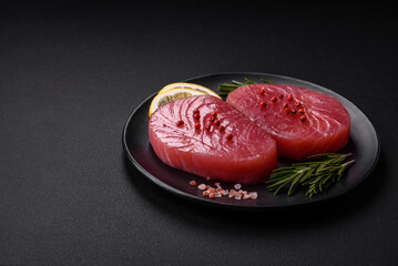 Two fresh slices of raw tuna fillet with spices and herbs