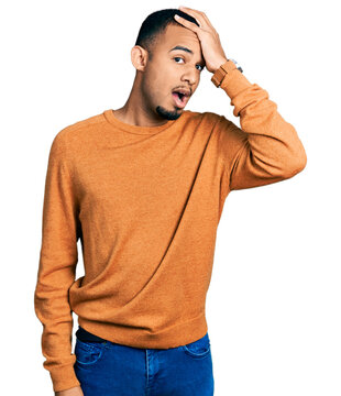Young african american man wearing casual clothes surprised with hand on head for mistake, remember error. forgot, bad memory concept.