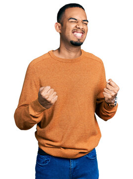 Young african american man wearing casual clothes celebrating surprised and amazed for success with arms raised and eyes closed. winner concept.