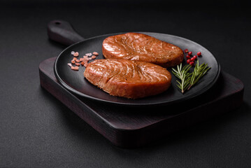 Two baked slices of tuna fillet with spices and herbs