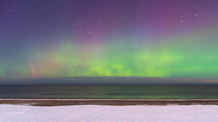 Aurora Borealis northen lights on the Baltic Sea beach at Jurmala, Latvia - obrazy, fototapety, plakaty