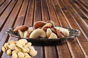 Mix of dry tasty nuts on a wooden desk